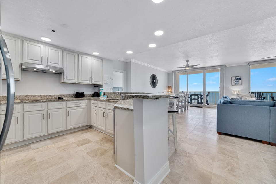 This fully functional kitchen boasts stainless steel appliances, sleek countertops, and ample cabinet storage, ideal for everyday cooking and entertaining.