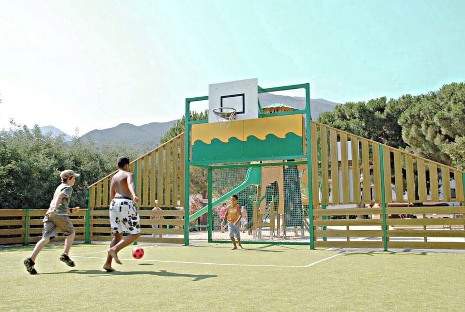 Outdoor sports court with basketball and soccer, perfect for active fun and friendly games.