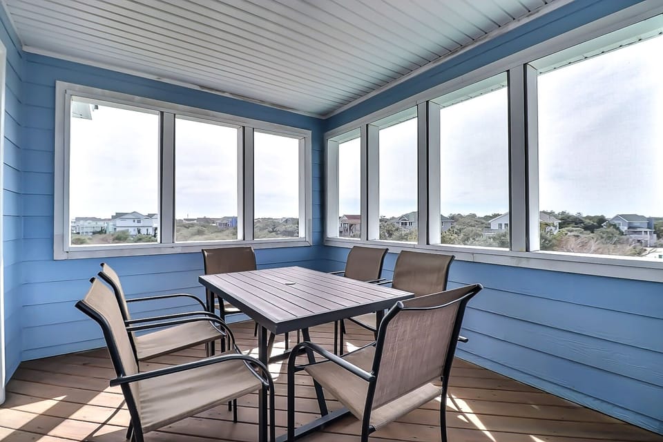Screened-in dining area in the top level of the house.