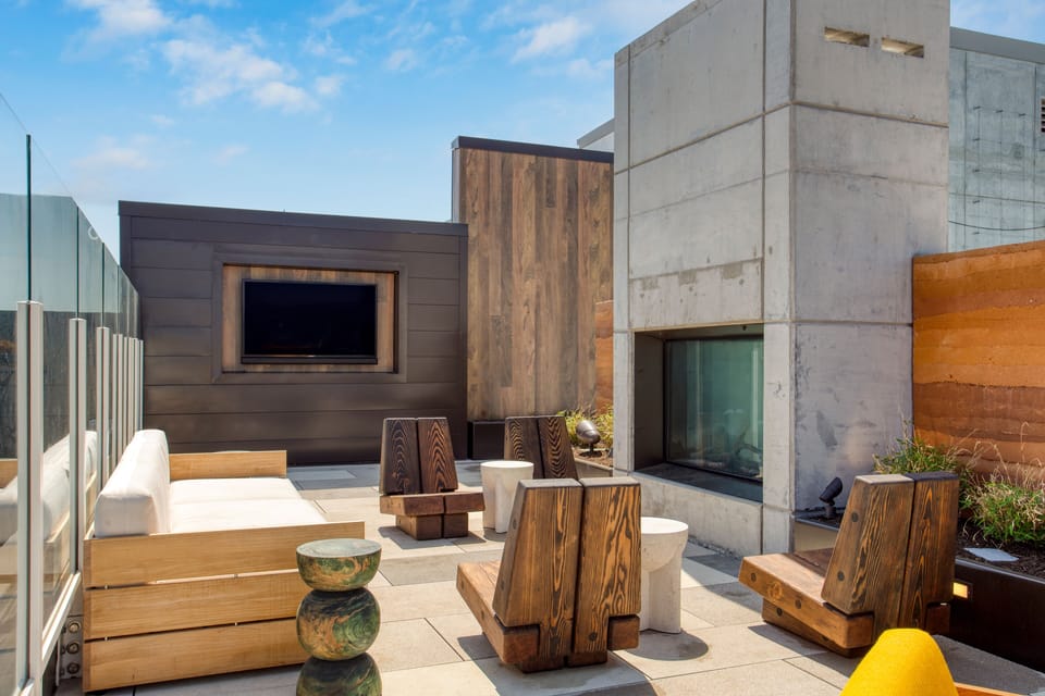 Rooftop lounge boasts an outdoor TV and fireplace.