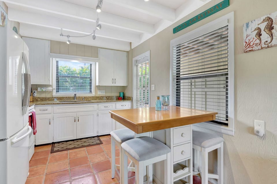 The Kitchen Has Great Natural Light and An Eat In Kitchen Set That Seats 4