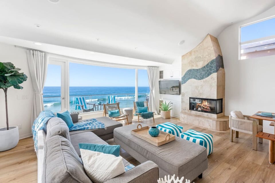 `Bright and open living space with Smart TV, ocean views, and comfortable seating – perfect for relaxing after a day at the beach.`