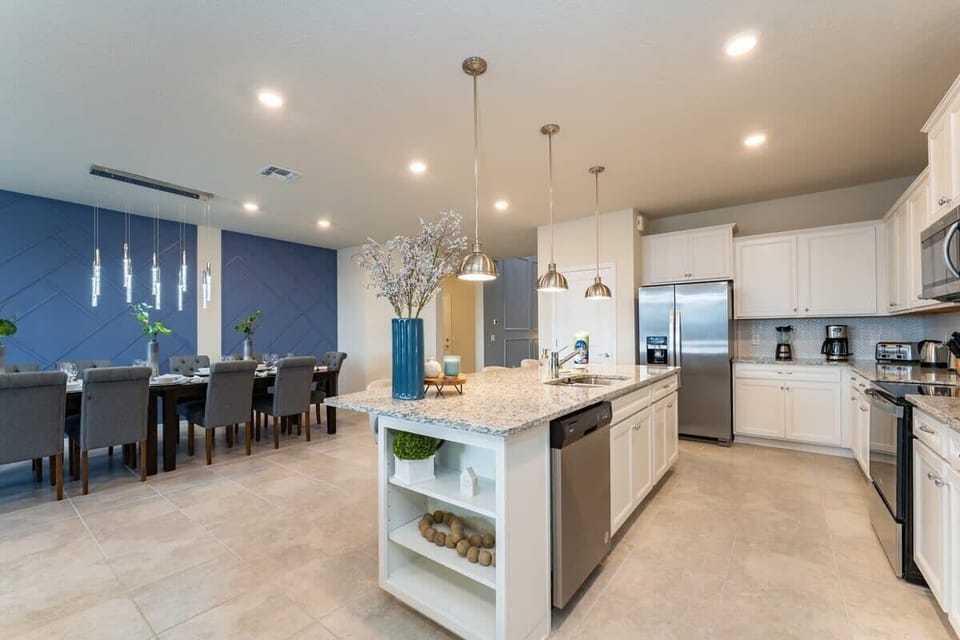 Modern kitchen with granite island and elegant dining area, perfect for family gatherings.