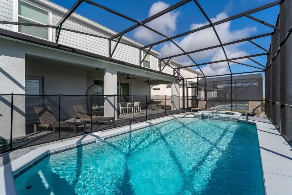 Relax in your private oasis with a sparkling pool, lounge chairs, and dining area under the sun.