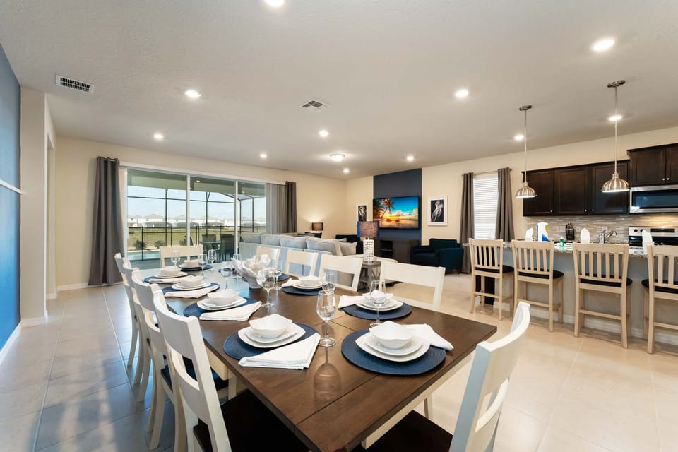 Elegant open-plan dining and living area with modern amenities and a seamless flow to the outdoor space, perfect for entertaining.