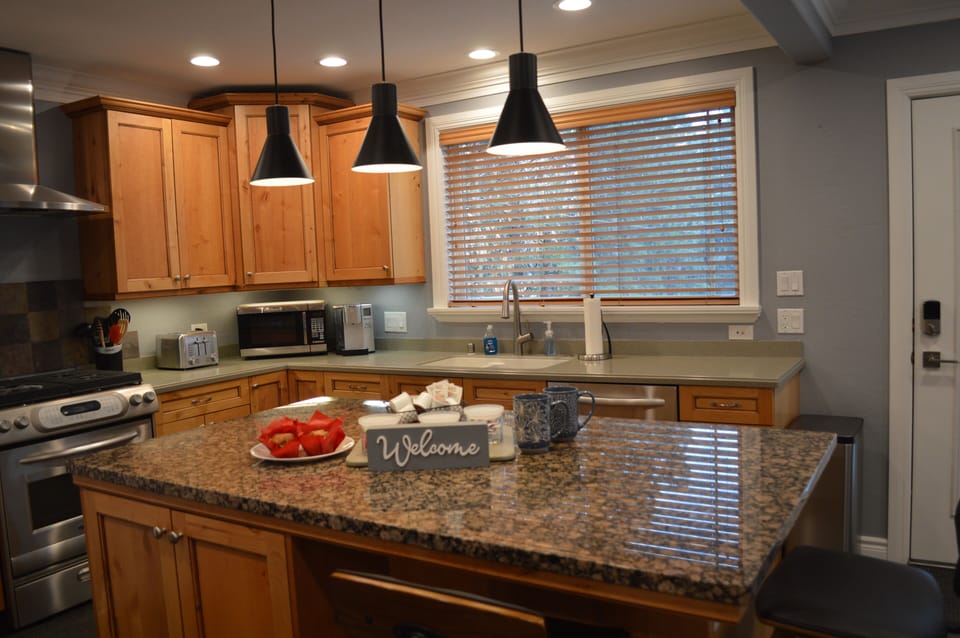 Kitchen with small appliances, dishwasher, and gas range.