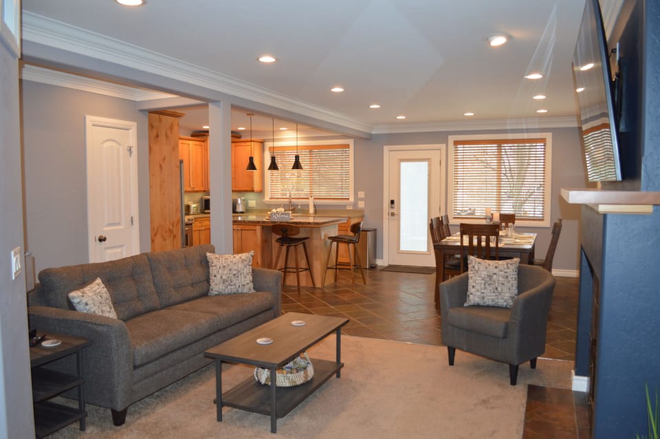 Open floor plan, living room, kitchen with island, and dining room.