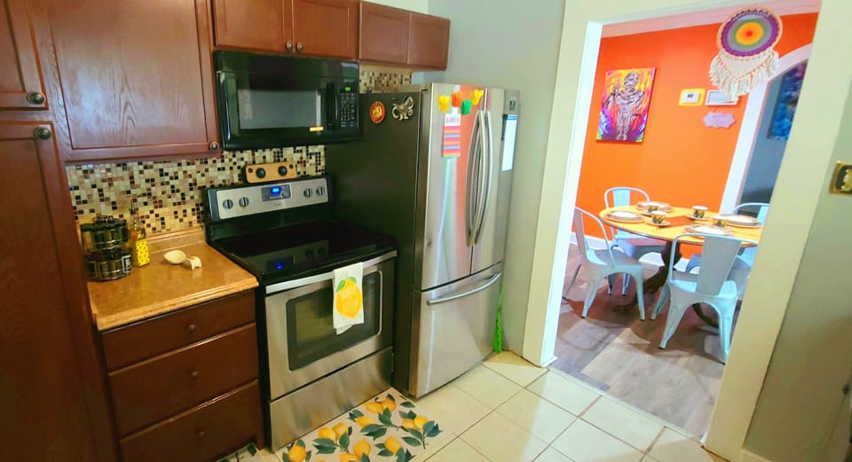 Electric stove, large fridge, water-filter pitcher and supplies for cooking. 