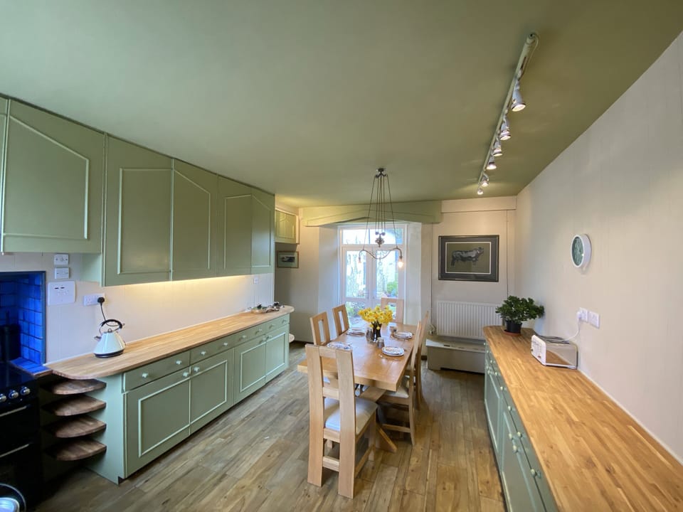 Large kitchen leading to separate utility room