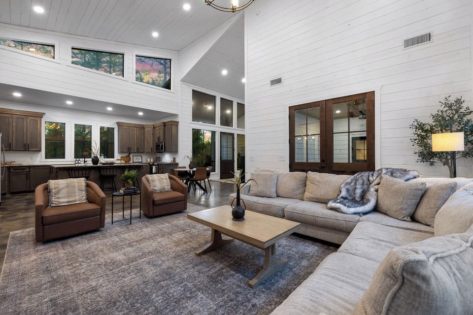Enjoy quality time with friends and family in a chic living area adorned with cozy seating, providing direct access to the inviting patio that lies just behind.