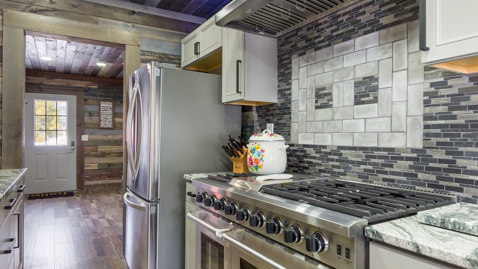A large stainless steel refrigerator with an ice maker is a high-end appliance that can provide all the necessary features for a gourmet kitchen. It adds a touch of luxury and practicality to the kitchen.