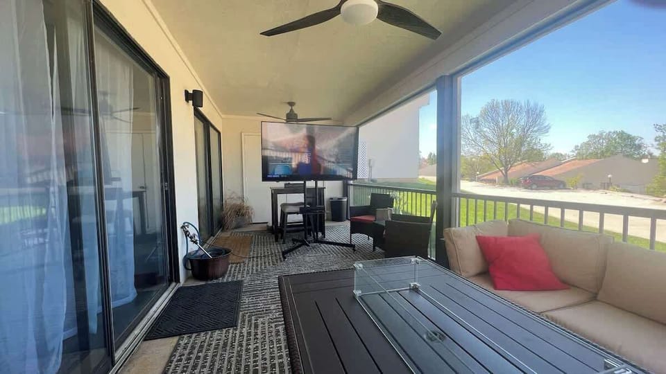 Patio with comfortable seating, fire table and TV that can be rolled out.