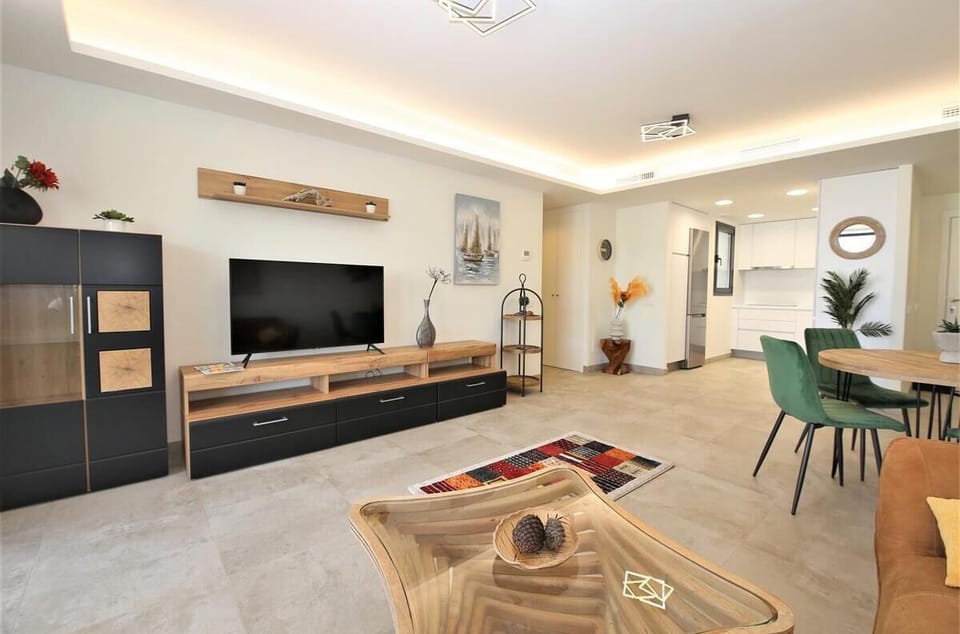 Stylish and spacious lounge with dining area and large TV