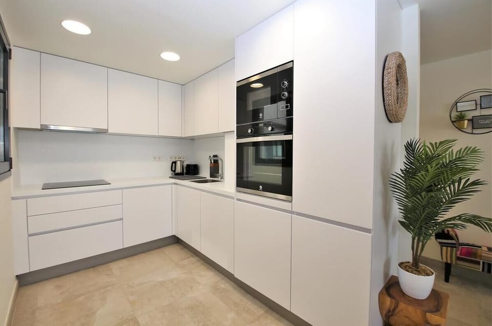 Modern open kitchen is fully fitted with all the appliances