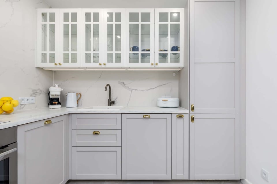 Another view of the kitchen showcasing glass-front cabinets and a modern layout.
