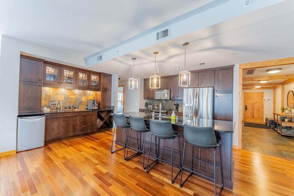 Kitchen with bar stools and pendant lighting