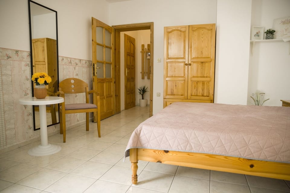 double bed, wardrobe, bedside tables,stool, armchair