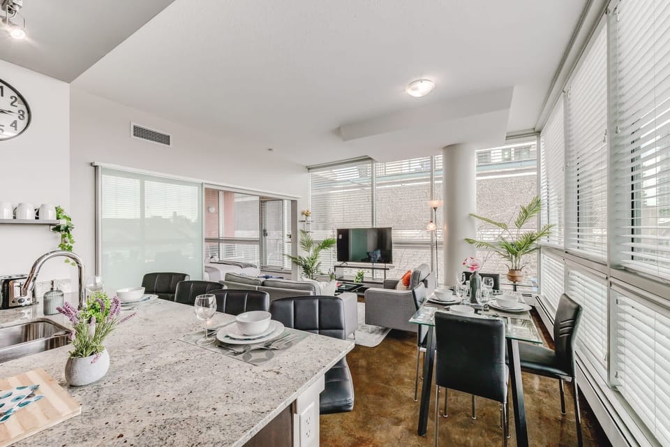 Modern Open-Concept Living With Kitchen, Dining, And Smart TV Setup