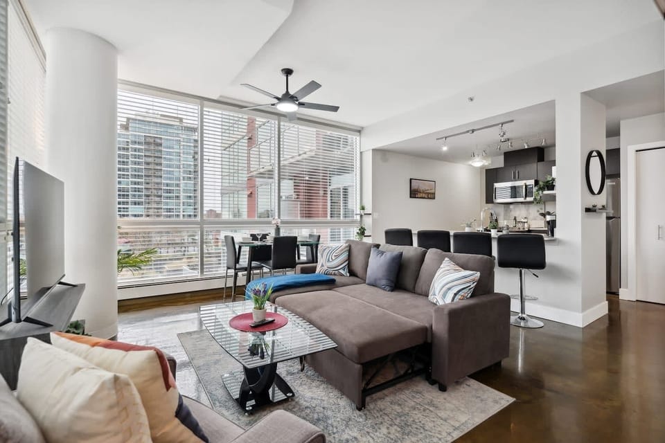Bright And Cozy Living Room With Smart TV For Your Entertainment