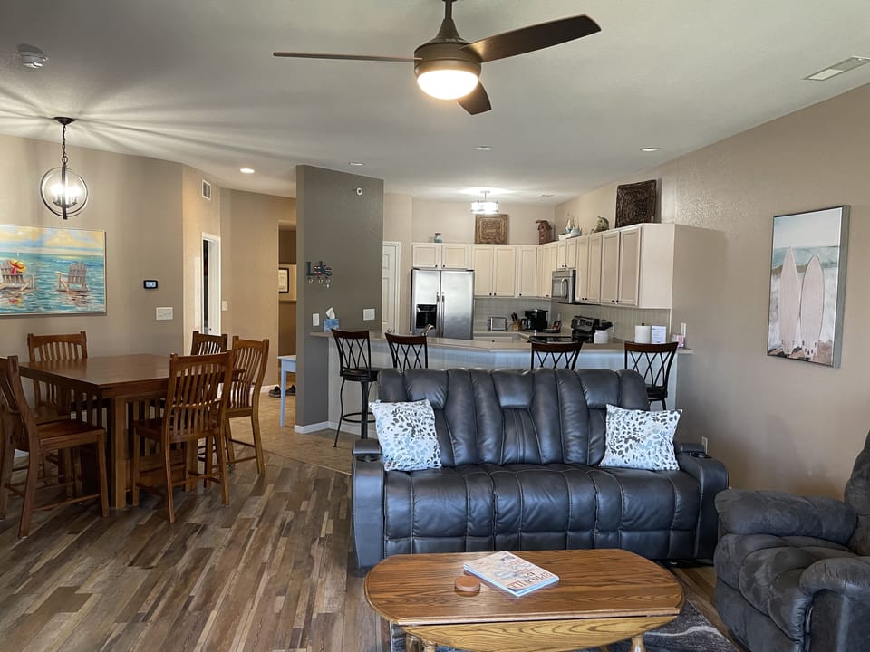 Open concept with view of living area, kitchen and dining.  Note table for 6