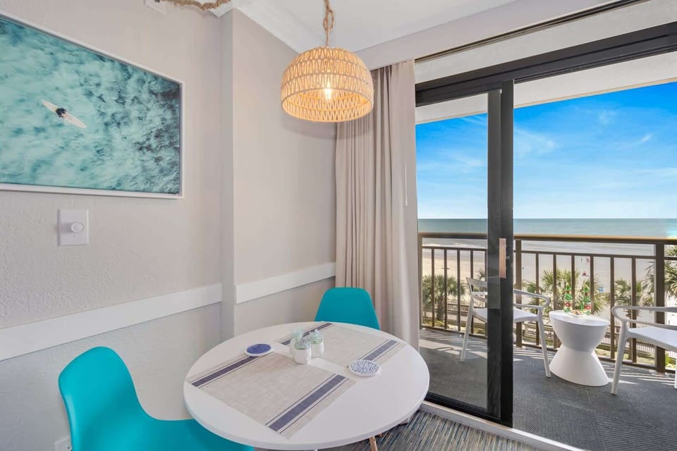 Cozy dining area with ocean views, perfect for enjoying meals with a breathtaking backdrop. Relax and unwind in this bright, inviting space!