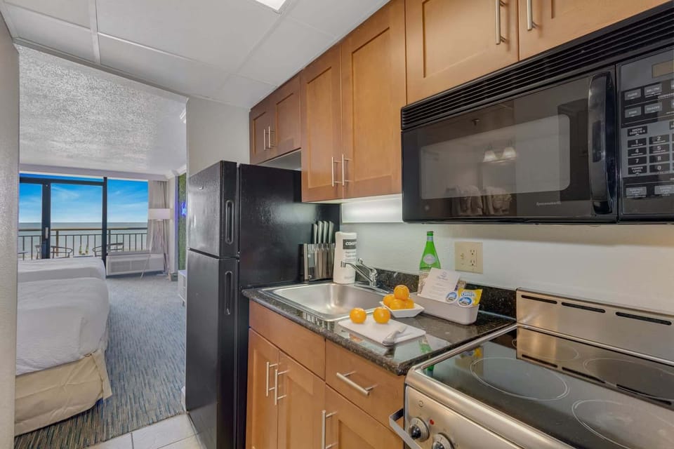 Bright, open kitchen with modern appliances and stunning ocean views. Perfect for cooking up a storm while enjoying the coastal breeze. 
