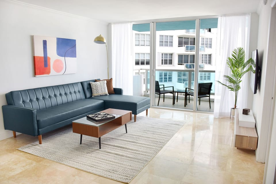Relax in the airy lounge with balcony light streaming in.