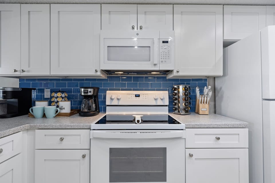 Fully stocked custom kitchen open to the living room.