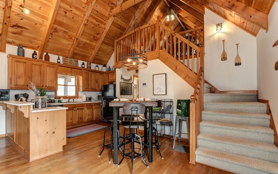 Loft game room with foosball table, rustic decor, and cozy seating area.