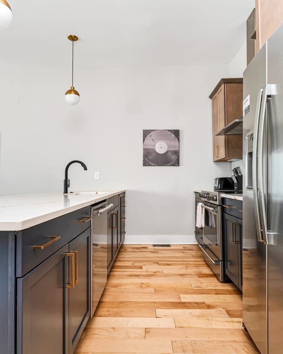 Modern, fully stocked kitchen with island housing sink and dishwasher.
