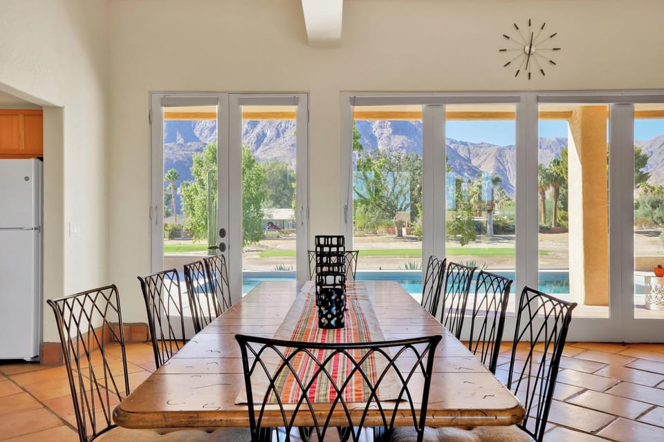 A serene and inviting dining space that combines rustic charm with modern elegance. The abundant natural light and the stunning outdoor view make this room a perfect spot for enjoying meals