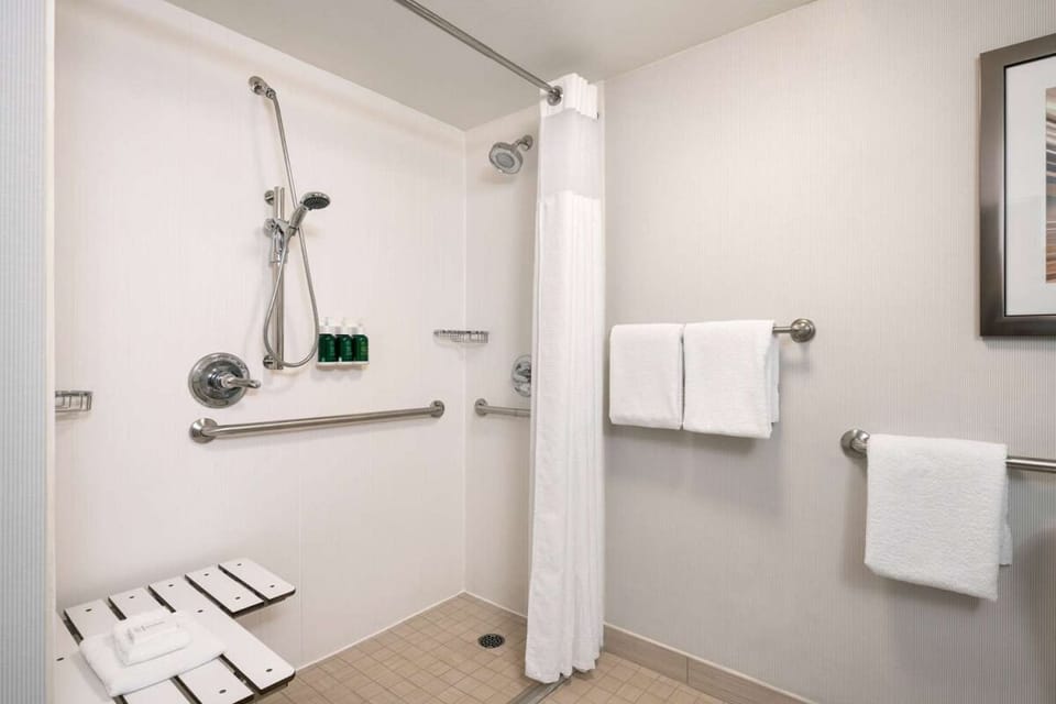 Enjoy an accessible walk-in shower with supportive grab bars.