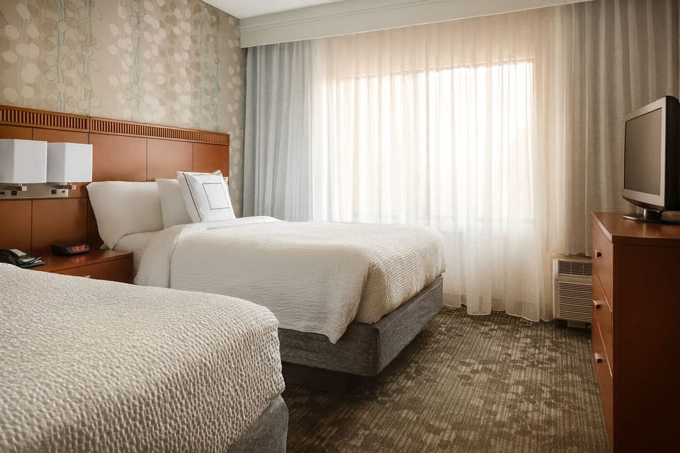 Drift off in cozy double beds with warm, calming tones.