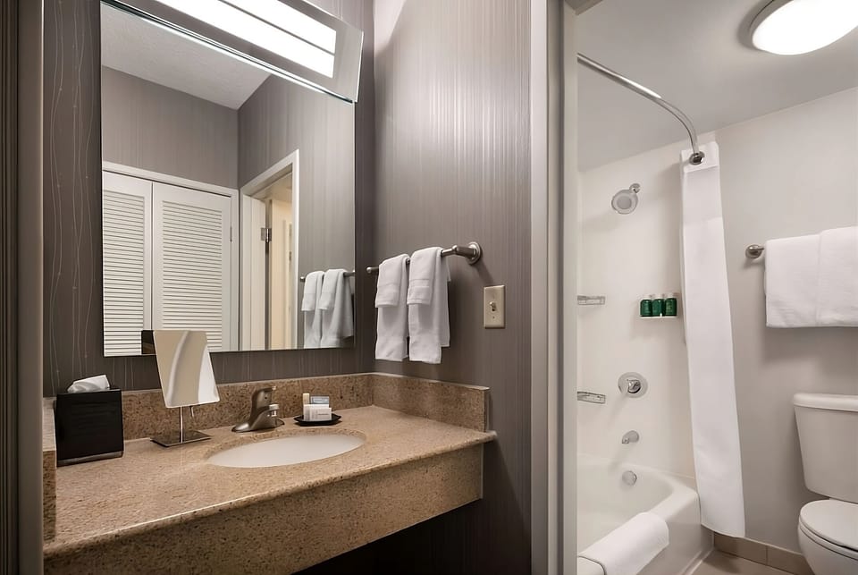 Refresh easily with a spotless vanity and tub-shower combo.