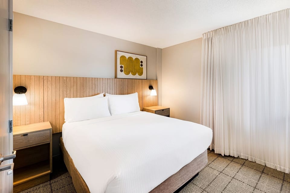 Sink into a serene bedroom with warm lighting and space.
