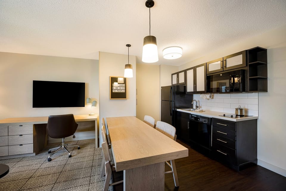 Cook simple favorites in a sleek kitchen with dining table.