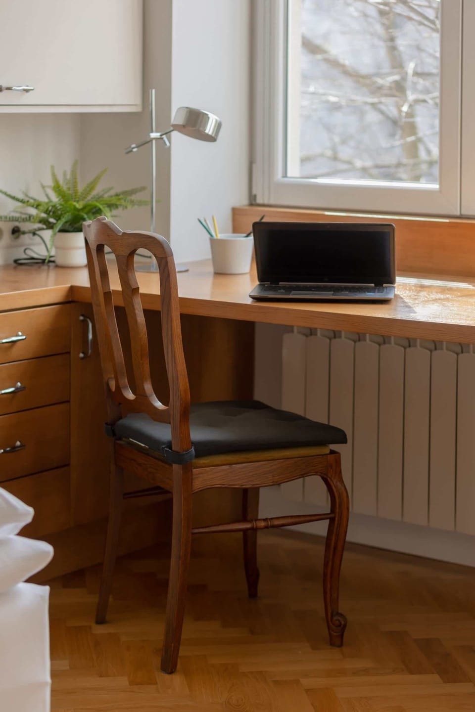 A workspace setup with a desk and chair by the window, perfect for working or studying.
