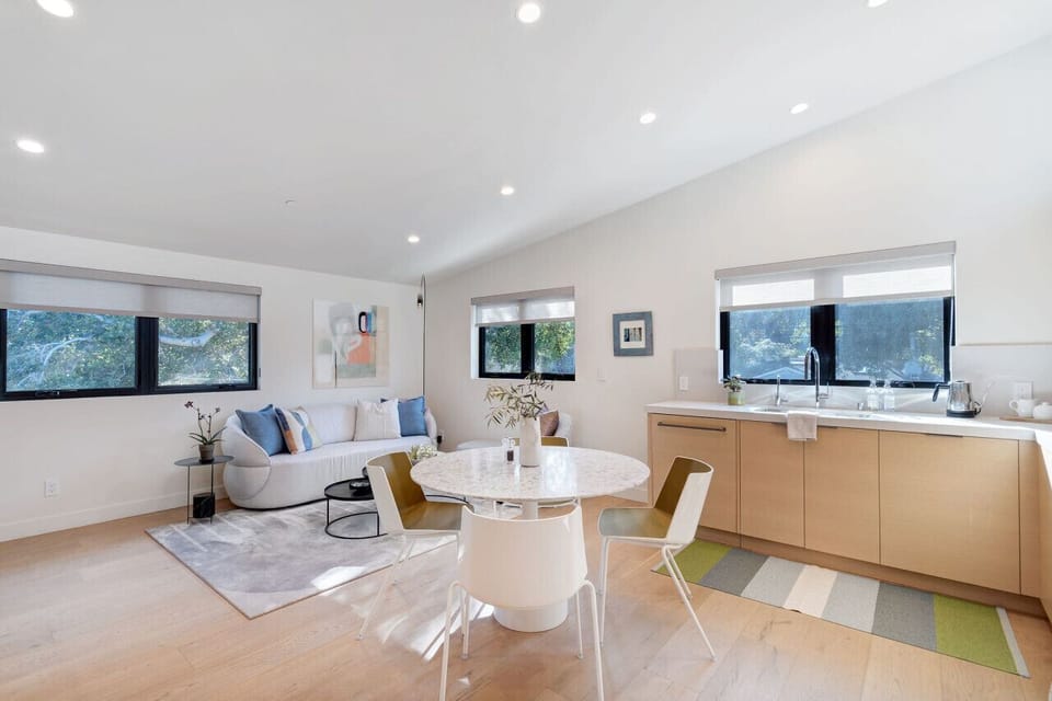 Savor a delightful meal at the dining table with a Terrazzo top, accompanied by designer chairs