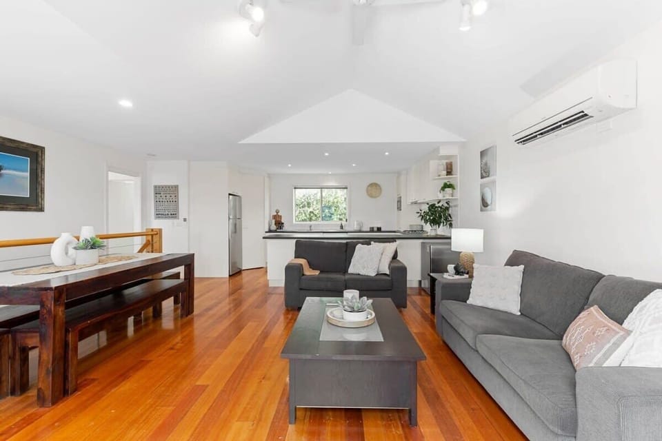 The open plan living and dining area overlooks the leafy surroundings, creating a serene setting for families