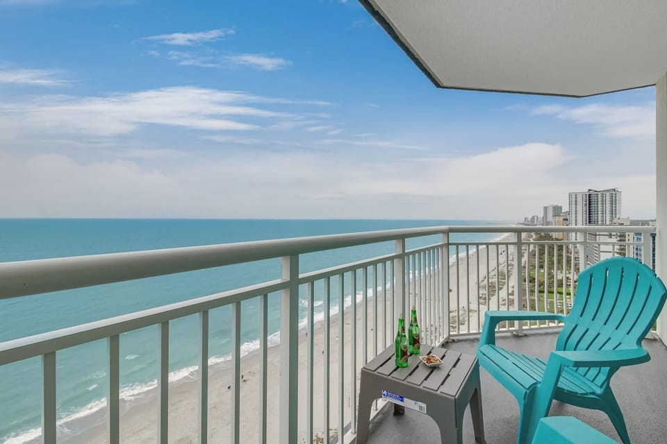 Private ocean-view balcony overlooking the beach, with outdoor seating for enjoying fresh coastal air and wide shoreline views.