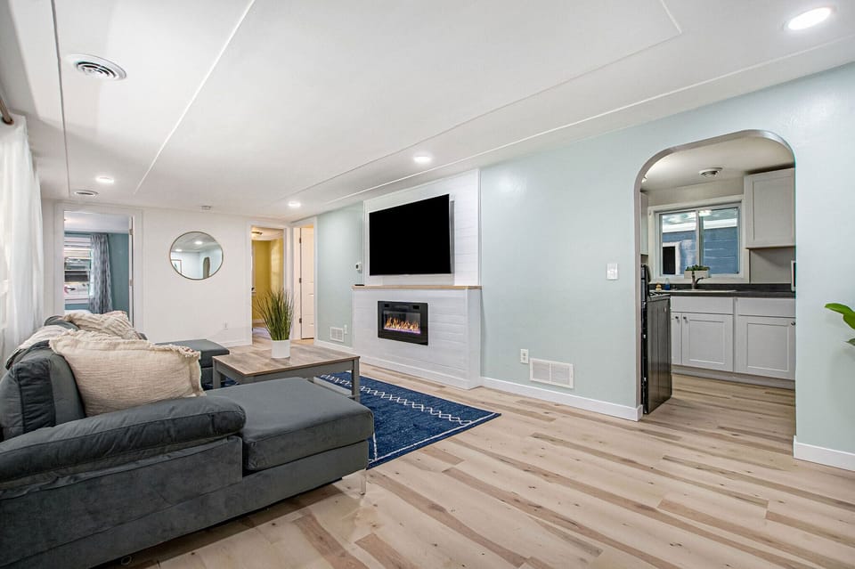 Living room with 65 inch flat screen and LED fireplace.