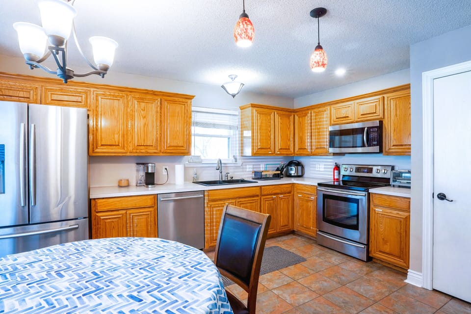 Fully stocked kitchen with modern amenities, designed for extended stays.  