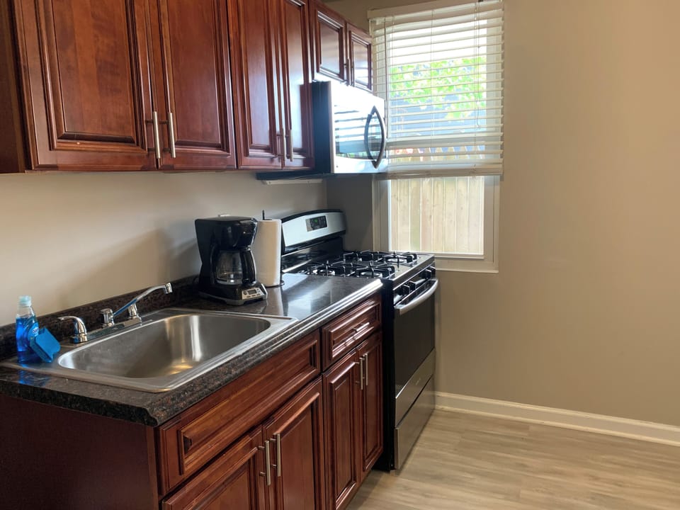 Bright, well-equipped kitchen with gas stove and coffee maker
