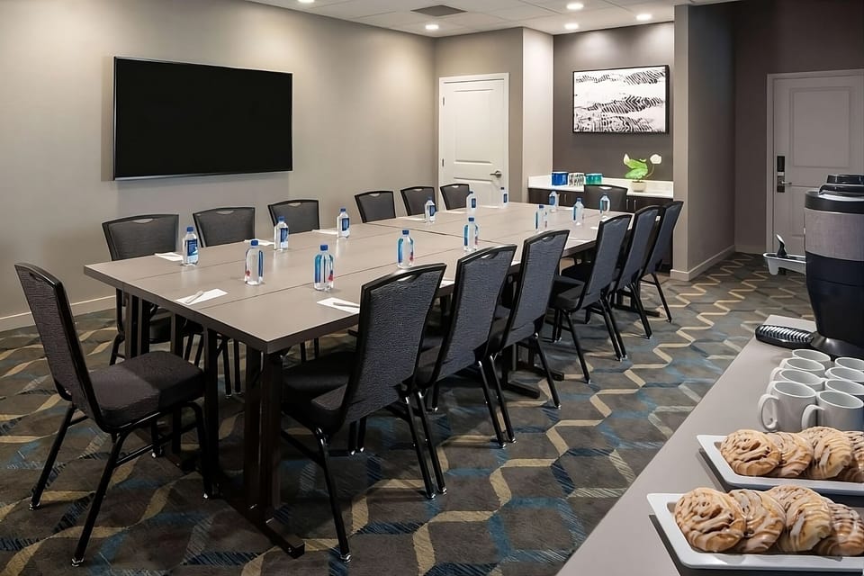 Collaborate comfortably around a boardroom table with convenient refreshments.
