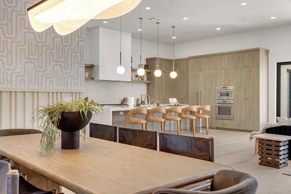 Gather & Dine in Style – This open-concept dining and kitchen area blends rustic charm with modern elegance, featuring seating for large groups and a seamless flow for entertaining.