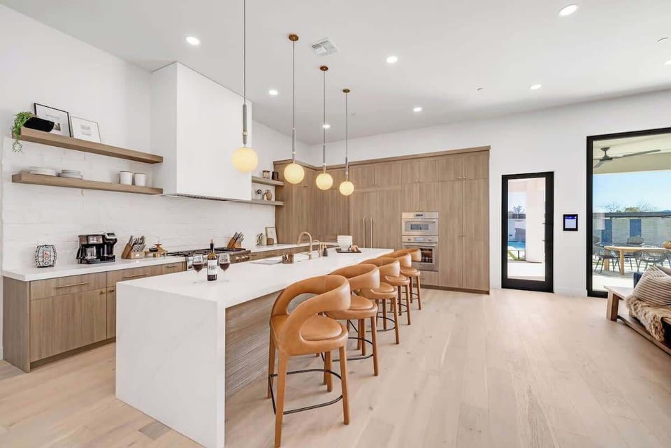 Spacious & Social – The oversized island with seating makes this kitchen the heart of the home – perfect for breakfast gatherings or evening cocktails with friends.