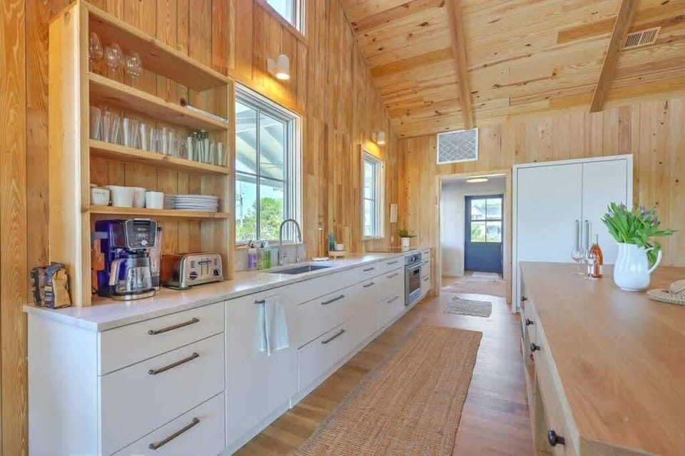 Fully equipped kitchen featuring modern appliances and ample counter space.