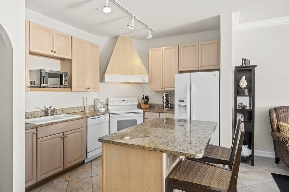 The large counter space also includes seating for 2 at the island, perfect for keeping the cook in your family company