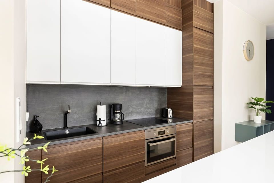 Your modern kitchen blends sleek design with practicality—wood tones contrast with concrete textures, giving you a stylish space to prepare meals and sip morning coffee.