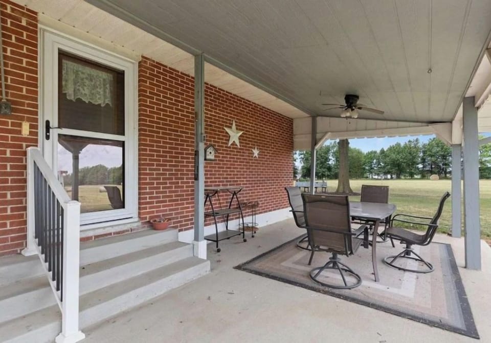 Patio with charcoal grill, ceiling fans, lights with Bluetooth, fire pit.